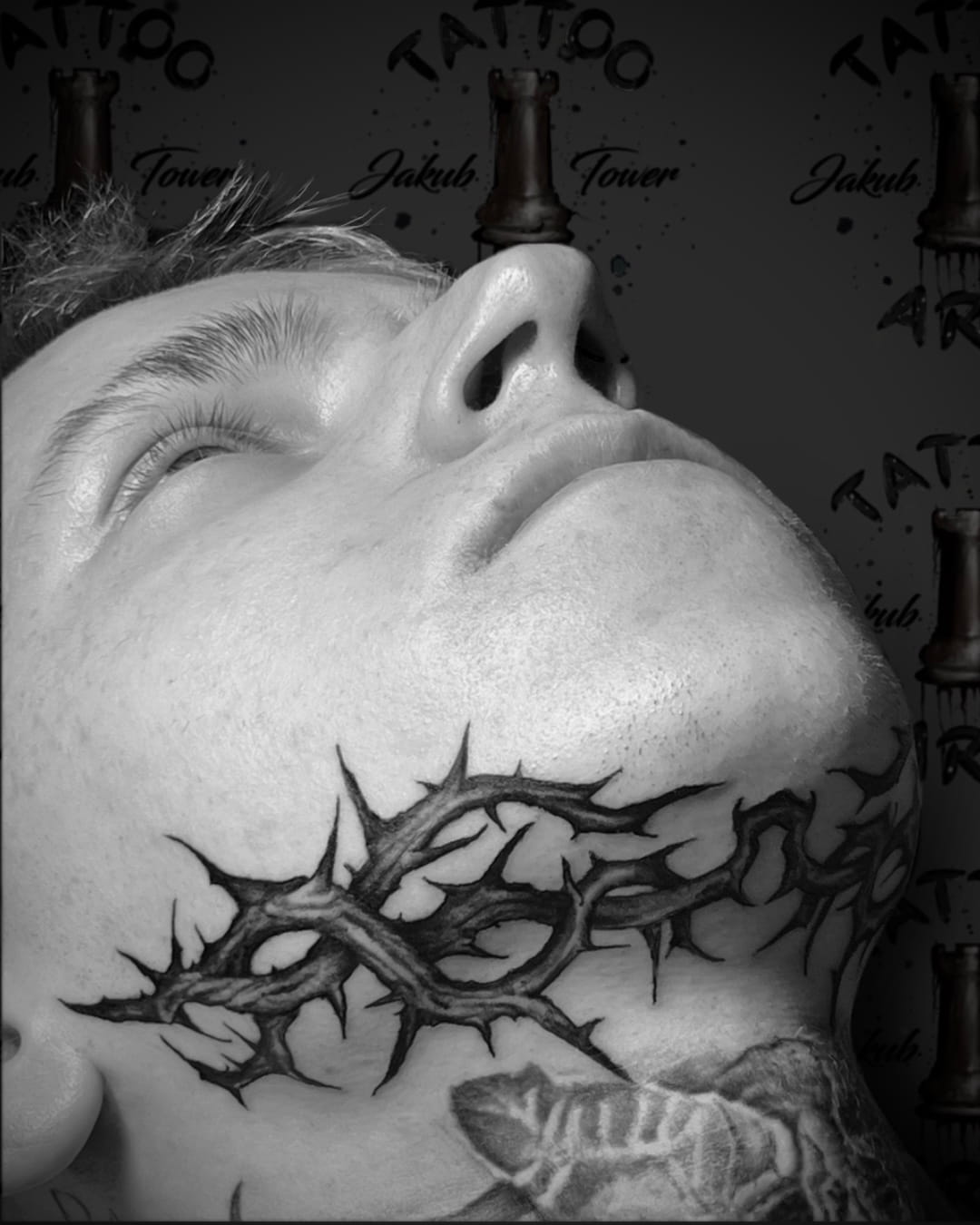 Face profile with thorn tattoo